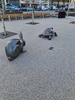 Statue of rabbit scracting himseelf & following turtle..jpg
